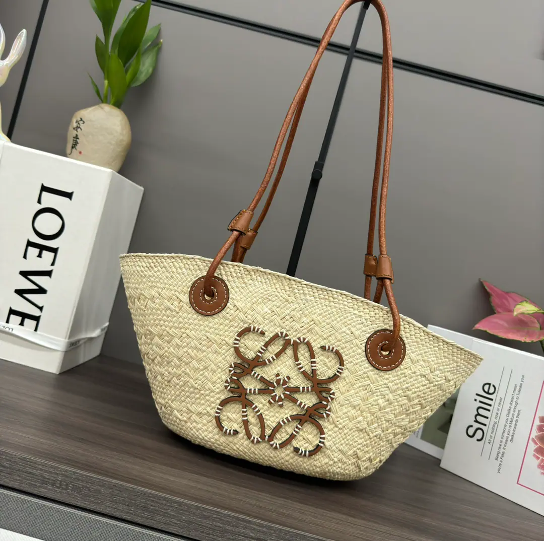 LO℮w℮🆕（High Version）🧺Iraka Palm Fibre and cattle leather Anagram Basket Handbag.*A traditional basket bag.*With a classic hand-woven body., A tube-shaped leather belt and a top handler.*And a piece of cattle leather. Anagram The version of the pressurized patch was made from Iraka Palm., These palm trees are grown in Colombia., Get it and dry it up., Then guided by fair trade principles. Corporación Oficio y Arte Organization of women craftsmen knitting. Hand-held shoulder or top*The leather belt is open.*Customize with personal hangers and tapes*No liner.*As a result of manual production, It may be a little different size., Makes every purchase unique.🧺 Model: 062136（Small） Size: 34*13*16.5CM